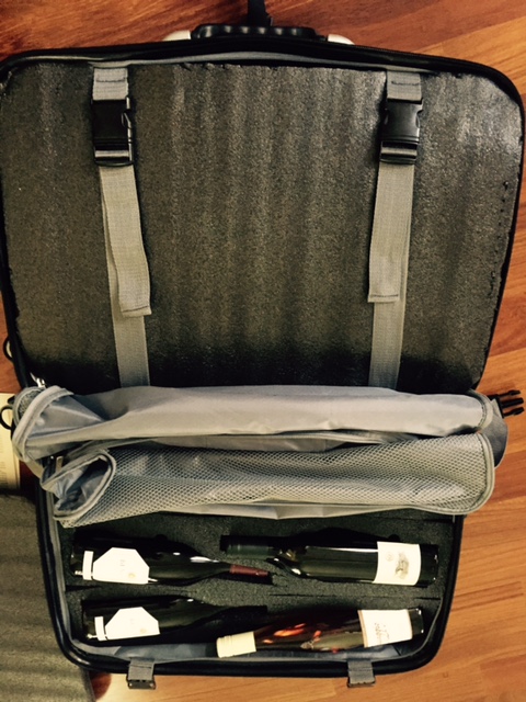 Once the bottles are in the cut-outs, there is another piece of foam that you strap in on top, which securely holds the bottles in place.