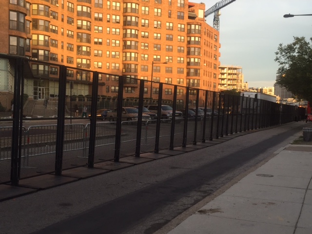 Nothing says “Peace, Love, and Understanding” better than a 4 foot high fence behind an eight foot high fence (which was going to be reinforced with a three foot high concrete highway barrier).
