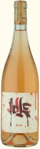 A bottle of rosé wine with a creative label featuring abstract art and the word 'rosé' prominently displayed.
