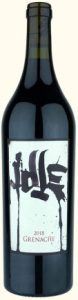 A bottle of 2018 Grenache wine with a minimalist label featuring artistic black text.